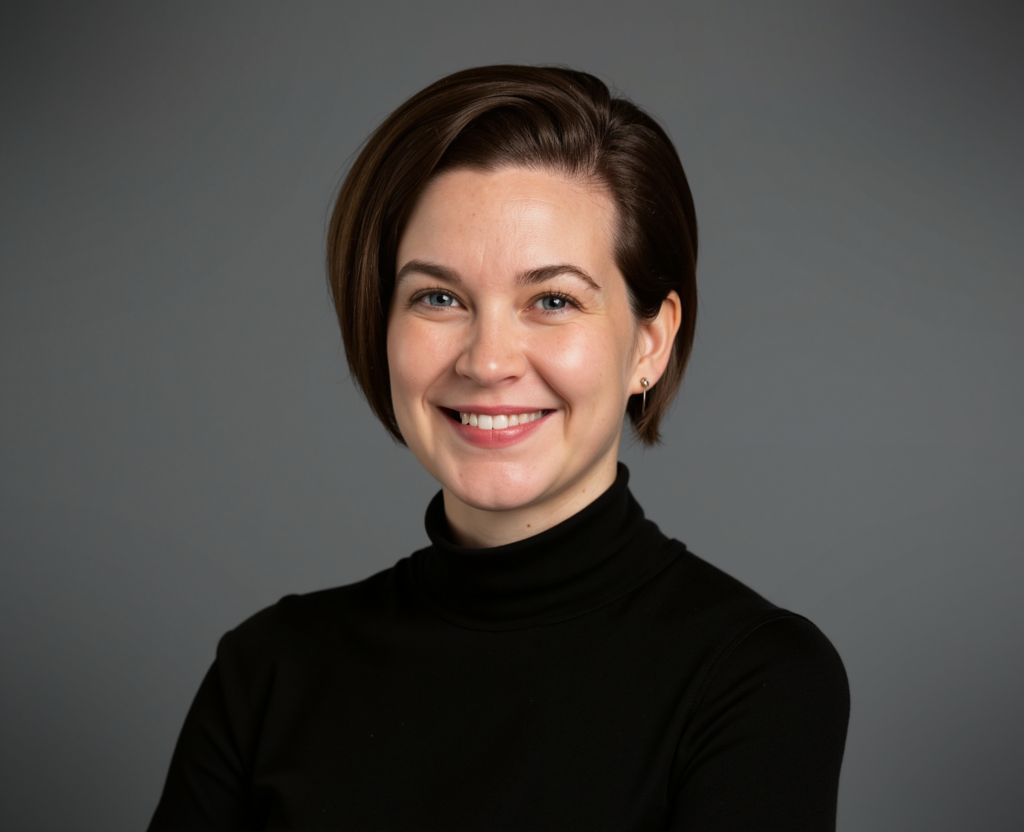 Color photograph of Callie Sopper from the shoulders up, staring into camera smiling.